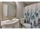 A simple bathroom features a modern sink and vanity, complimented by a toilet and shower curtain at 2220 Golden Valley Dr, Lawrenceville, GA 30043