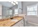 A well-lit bathroom with a granite countertop and white cabinets, featuring a large mirror and natural light at 2220 Golden Valley Dr, Lawrenceville, GA 30043