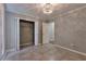 A light gray bedroom features neutral decor and tiled floor, complete with a walk-in closet at 2220 Golden Valley Dr, Lawrenceville, GA 30043