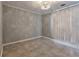 A light gray bedroom with tiled floor features neutral decor, highlighted by a decorative light fixture at 2220 Golden Valley Dr, Lawrenceville, GA 30043
