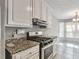 Kitchen featuring stainless steel stove, custom cabinets, and breakfast nook at 2220 Golden Valley Dr, Lawrenceville, GA 30043