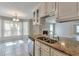 Granite kitchen island sink with living room and breakfast nook views at 2220 Golden Valley Dr, Lawrenceville, GA 30043