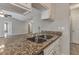 Granite countertop island with a double sink overlooks the living room at 2220 Golden Valley Dr, Lawrenceville, GA 30043