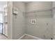 A utility room features gray walls and ceramic tile flooring, along with a wire shelf for added storage at 2220 Golden Valley Dr, Lawrenceville, GA 30043