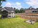 Beautiful backyard with green lawn, firepit area, and a view of the home's exterior at 1930 Collins Hill Rd, Lawrenceville, GA 30043