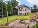 A backyard with lush lawn, fire pit, string lights and trees at 1930 Collins Hill Rd, Lawrenceville, GA 30043