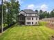 Expansive backyard featuring a well-maintained lawn and stylish exterior of the home at 1930 Collins Hill Rd, Lawrenceville, GA 30043