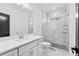 Bright bathroom with a glass enclosed shower, vanity, and modern fixtures at 1930 Collins Hill Rd, Lawrenceville, GA 30043