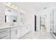 Modern bathroom with double vanity, shiplap wall detail, and marble floors at 1930 Collins Hill Rd, Lawrenceville, GA 30043