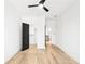 Bedroom with modern ceiling fan, wood floors, and sleek black door at 1930 Collins Hill Rd, Lawrenceville, GA 30043