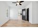 Bright bedroom with hardwood floors, open doorway, and a view of the living room with a fireplace and shelving at 1930 Collins Hill Rd, Lawrenceville, GA 30043