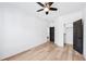 Bedroom with modern ceiling fan, wood floors, and sleek black door at 1930 Collins Hill Rd, Lawrenceville, GA 30043