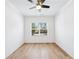 Bright bedroom with modern ceiling fan, wood floors, and large window at 1930 Collins Hill Rd, Lawrenceville, GA 30043