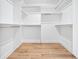 Bright closet with built-in shelving and hanging rods at 1930 Collins Hill Rd, Lawrenceville, GA 30043