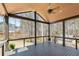 Covered deck with wood ceiling, ceiling fan, and views of private, wooded backyard at 1930 Collins Hill Rd, Lawrenceville, GA 30043