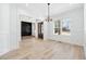 Elegant dining room featuring hardwood floors, decorative molding, and modern lighting fixture at 1930 Collins Hill Rd, Lawrenceville, GA 30043
