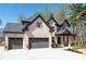 Stunning two-story home featuring brick exterior, three-car garage, and manicured landscaping at 1930 Collins Hill Rd, Lawrenceville, GA 30043
