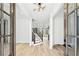 Grand foyer featuring hardwood floors, staircase with black iron railings, and coffered ceiling at 1930 Collins Hill Rd, Lawrenceville, GA 30043