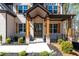 Inviting front entrance with charming porch, wood columns, and well-maintained landscaping at 1930 Collins Hill Rd, Lawrenceville, GA 30043
