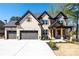 Beautiful two-story home with a three-car garage, brick facade, and welcoming front porch at 1930 Collins Hill Rd, Lawrenceville, GA 30043