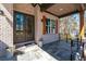 Inviting front porch with brick façade, wooden shutters, and a cozy seating area at 1930 Collins Hill Rd, Lawrenceville, GA 30043