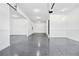 Clean and organized garage with epoxy flooring, ample space, and well-lit interiors, perfect for storage and vehicle parking at 1930 Collins Hill Rd, Lawrenceville, GA 30043