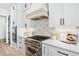 Gourmet kitchen showcasing stainless steel appliances, tile backsplash, and quartz countertops at 1930 Collins Hill Rd, Lawrenceville, GA 30043