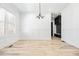 Open living area with hardwood floors, modern lighting, and a view of the mudroom's storage at 1930 Collins Hill Rd, Lawrenceville, GA 30043
