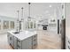 Bright, open-concept space with island, hardwood floors, fireplace, and wall of windows at 1930 Collins Hill Rd, Lawrenceville, GA 30043