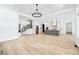Open-concept space with hardwood floors, modern lighting, and seamless flow between the living, dining, and kitchen areas at 1930 Collins Hill Rd, Lawrenceville, GA 30043