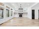 Bright living room boasts large windows, a fireplace with stone surround, and hardwood floors with built-in shelving at 1930 Collins Hill Rd, Lawrenceville, GA 30043