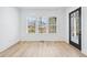 Sunlit living room with shiplap walls, hardwood floors, and a large window offering natural light at 1930 Collins Hill Rd, Lawrenceville, GA 30043