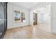 Bright, open living room features hardwood floors, large window, and stylish white wainscoting at 1930 Collins Hill Rd, Lawrenceville, GA 30043