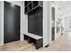 Well-organized mud room boasts a built-in bench with hooks and storage, adjacent to a sleek black door at 1930 Collins Hill Rd, Lawrenceville, GA 30043