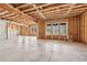 Spacious unfinished basement framed with wooden beams, windows and concrete floor at 1930 Collins Hill Rd, Lawrenceville, GA 30043