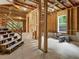 Unfinished basement with wooden frame walls, staircase, and exposed ceiling at 1930 Collins Hill Rd, Lawrenceville, GA 30043