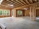 Large unfinished basement with concrete floor, wooden framing, and natural light at 1930 Collins Hill Rd, Lawrenceville, GA 30043