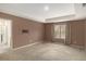 Spacious bedroom with tray ceiling, plush carpeting, and en-suite bathroom access at 3045 Hendrick Dr, Mcdonough, GA 30253