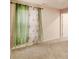Bedroom featuring neutral carpet, light pink walls, and a window with green drapes and floral sheers at 3045 Hendrick Dr, Mcdonough, GA 30253