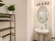 Stylish half-bathroom featuring a pedestal sink and decorative mirror at 3045 Hendrick Dr, Mcdonough, GA 30253
