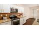 Modern kitchen with granite countertops, stainless steel appliances, and hardwood floors at 3045 Hendrick Dr, Mcdonough, GA 30253