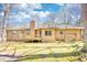 Ranch home with level lot featuring a wood porch, wood swing, and attached garage at 380 Hidden Valley Sw Dr, Conyers, GA 30094