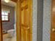 Water closet featuring patterned wallpaper and a toilet near a window at 380 Hidden Valley Sw Dr, Conyers, GA 30094