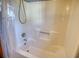 Clean bathtub with shower and a curtain in a neutral-colored bathroom at 380 Hidden Valley Sw Dr, Conyers, GA 30094