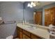 Bathroom featuring a vanity with sink, large mirror, and a floral-patterned wallpaper at 380 Hidden Valley Sw Dr, Conyers, GA 30094