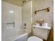 Bathroom featuring a white shower-tub combo, floral wallpaper, and white toilet at 380 Hidden Valley Sw Dr, Conyers, GA 30094