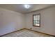 Simple bedroom featuring neutral carpeting, a window for natural light, and white walls at 380 Hidden Valley Sw Dr, Conyers, GA 30094