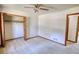 Carpeted bedroom with a closet, neutral walls and ceiling fan at 380 Hidden Valley Sw Dr, Conyers, GA 30094