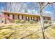 Traditional brick home with a covered porch and mature trees providing shade in the front yard at 380 Hidden Valley Sw Dr, Conyers, GA 30094