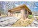 Spacious two-car garage attached to a brick home with a driveway and sidewalk at 380 Hidden Valley Sw Dr, Conyers, GA 30094